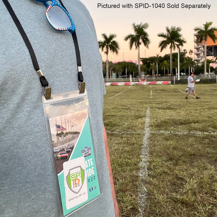 A person wearing a double-sided lanyard with a badge that says "SPID 19 Inc. 2022" on a grassy sports field, with another person and palm trees in the background. Text reads "Pictured with 25 Pack Bulk Double-Ended Lanyards with Bulldog Clips on Each Side Assorted Colors - Sold Separately.