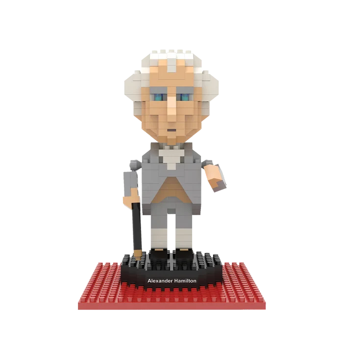 The image shows a rendering of the assembled mini-block Alexander Hamilton figure, posed on a black base with a red platform beneath it, set against a white background.