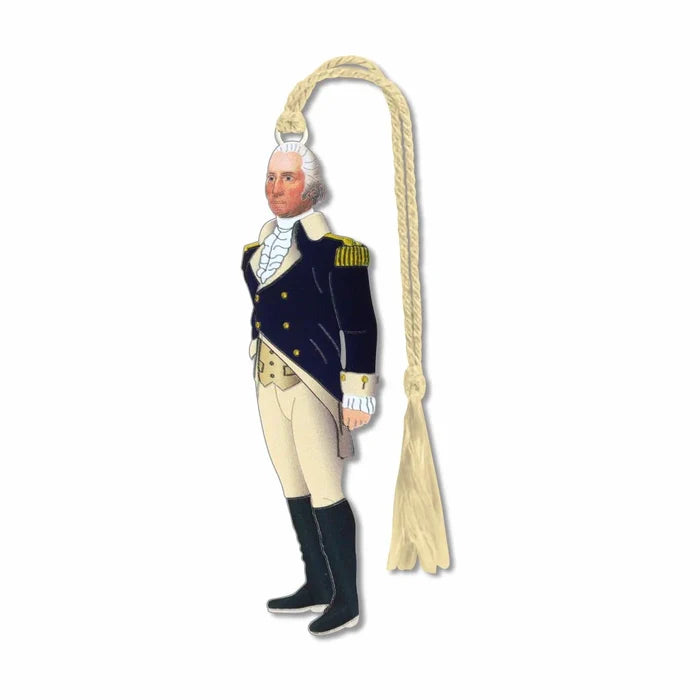 Metal bookmark ornament of George Washington standing against a white background, wearing a navy coat with gold buttons, a yellow vest, and light‑yellow breeches. A white cravat is tied at his neck, and a small yellow fabric loop at the top serves as a placeholder in a book. The thin, etched metal gives the bookmark a distinct tactile feel, making it easy to locate by touch between pages.