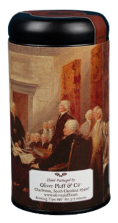The image shows a tall, tubular tea canister with a round black lid, holding 20 fully biodegradable pyramid teabags of bold black tea with a warm, lightly smoky aroma. The smooth matte black tin features historic artwork celebrating the 250th anniversary of the Declaration of Independence, rendered in deep reds, warm browns, dark blues, and soft cream tones, with a shelf life of up to three years.