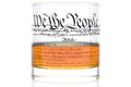 This 11 oz rocks glass is made of clear, heavy glass with a weighted base and a smooth, chip‑resistant rim. Near the top, “We the People” appears in period‑style cursive, while the exterior is wrapped with printed text of the U.S. Constitution. A clear orange band with additional cursive text encircles the lower half of the glass.