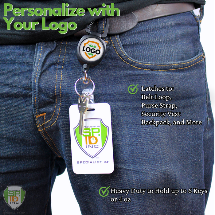 A person wearing jeans has a keychain with a logo attached to a belt loop via a Custom Compact Key-Bak Retractable Carabiner ID Badge Reel with Key Ring and Your Logo. The keychain also carries an ID card, secured by the retractable Kevlar cord of the Key-Bak. Text on the image lists uses and weight capacity of the clip.
