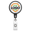 A Customizable Key-Bak Mid Size ID Badge Reel with Steel Belt Clip (6ID) - Upload Your Logo with customizable text reading "Your Logo Here" on a white background featuring an orange and green shield design. Enhance brand awareness with this badge holder, which includes a convenient clip at the bottom.