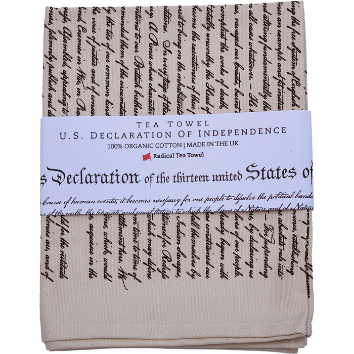 White cotton tea towel printed with the Declaration of Independence in black text, presented folded and wrapped with a printed belly band.