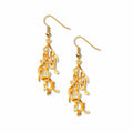 Gold earrings with intricate design of musical notes on a white background