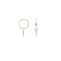 Small sterling silver huggie hoop earrings with a smooth, rounded shape and a tiny dangling spike charm. Lightweight and understated, they combine a classic hoop silhouette with a subtle punk-inspired edge. About half an inch across, they close securely with a hinged clasp.