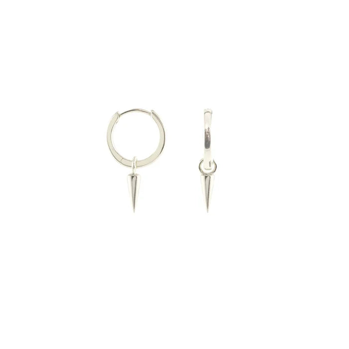 Small sterling silver huggie hoop earrings with a smooth, rounded shape and a tiny dangling spike charm. Lightweight and understated, they combine a classic hoop silhouette with a subtle punk-inspired edge. About half an inch across, they close securely with a hinged clasp.