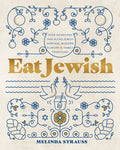 Book title: Eat Jewish. A blue line folk‑art drawing shows apples, doves, a honey jar, and challah bread against a white background. The title appears in the horizontal center of the cover, set in mustard‑yellow lettering.