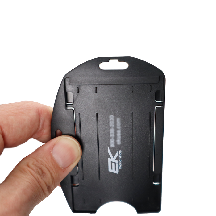 A hand holds a sleek Black EK Dual Sided Smart Card Holder with Slot Holes (10574) by EK USA, prominently showcasing the EK USA branding. Sold by Specialist ID.