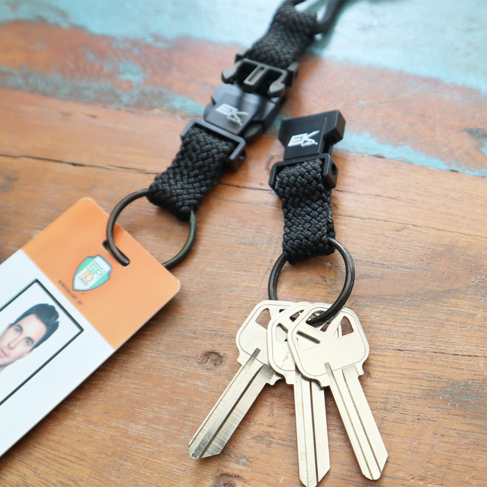 The EK Black Lanyard With Two Detachable Key Rings (10046) by EK USA securely holds a photo ID card and keys with its durable nylon braid. Sold by Specialist ID.