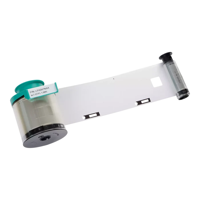 A clear patch lamination ribbon, like the Evolis LPA047NAA 1.0 mil Alternate Clear Patch with Smart Cut Laminate (600 prints, for Primacy and Primacy 2 Laminators), unspools from its cylindrical canister against a white background.