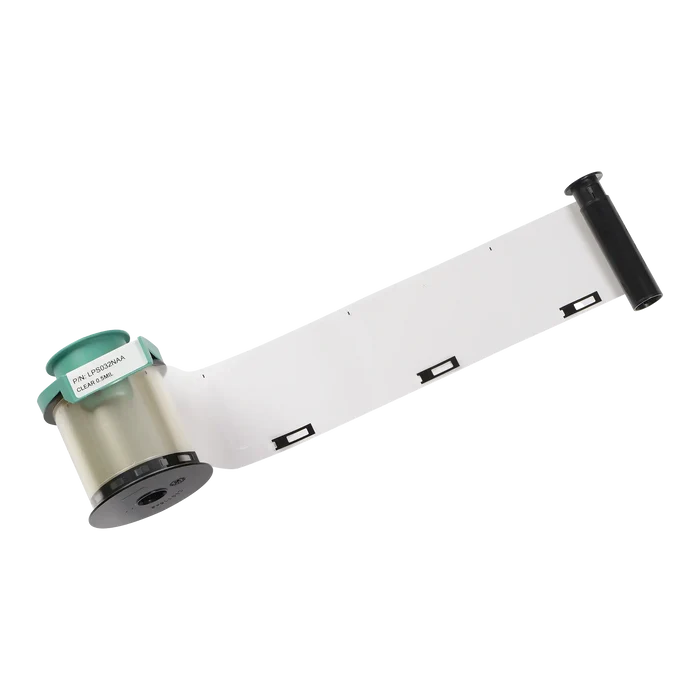 A long strip of white photo film partially unwound from a black and green cartridge with the label "PRF 1/03134AA" adhered to the side, resembling the precision you’d expect from Evolis LPS032NAA Clear Patch Laminate - 600 Prints, 0.5 Mil for Primacy2 and Avansia Lamination ID Card Printers.