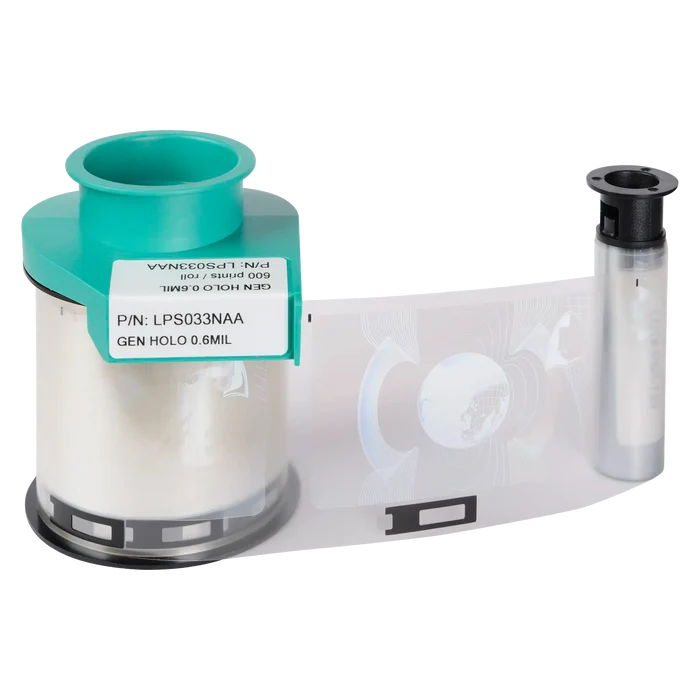 A roll of security holographic film in a green plastic holder, marked "GEN HOLO 0.6MIL," sits alongside a small cylindrical container, perfect for use with Evolis LPS033NAA Generic Holo Patch Laminate - 600 Prints, compatible with Primacy2 and Avansia lamination for your ID card printer.