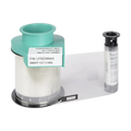 On a white surface, a roll of clear patch lamination ribbon with a teal spool and an attached label sits next to a small cylindrical black and gray component. The Evolis LPS034NAA Clear Smart Cut Patch Lamination, compatible with Primacy, Primacy2, and Avansia Lamination ID Card Printers, ensures high-quality results for your ID card printing needs.