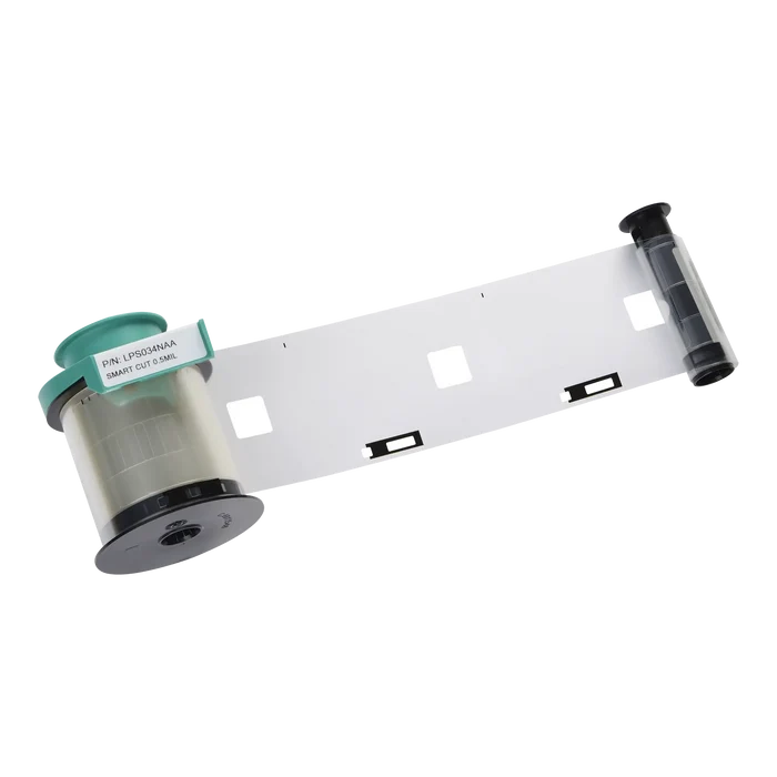 A roll of the Evolis LPS034NAA Clear Smart Cut Patch Lamination ribbon with a teal and black casing, unrolled to display the clear film with rectangular cutouts, compatible with Primacy, Primacy2, and Avansia Lamination ID Card Printers for up to 600 prints.