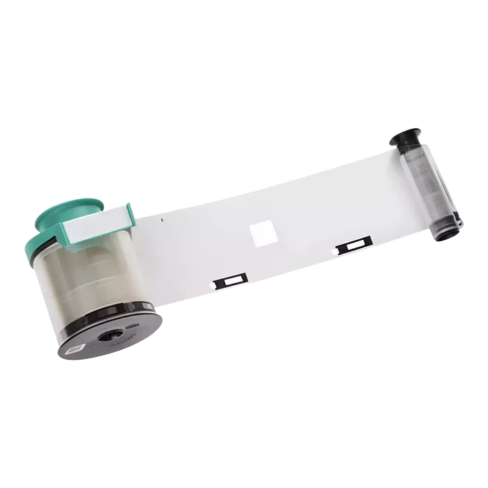 The Evolis LPS071NAA Clear Patch Smart Cut 1.0 mil Laminate, 600 Patches, features a blank ribbon with a green spindle and clear film unspooled against a white background—perfect for product media or listing on a product page.