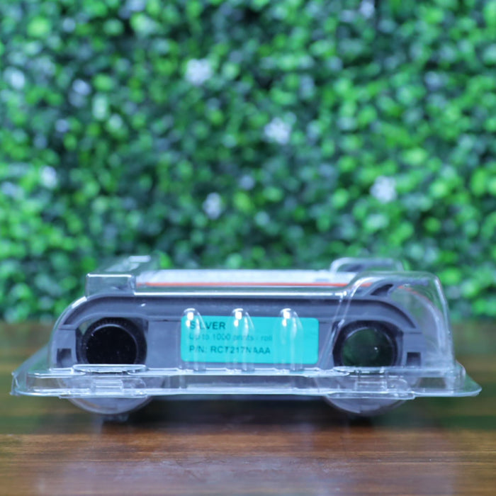 Bottom view of the Evolis RCT217NAAA metallic silver monochrome ribbon showing the product label with print capacity and part number through clear blister packaging. Photographed and sold by Specialist ID, an authorized Evolis dealer.