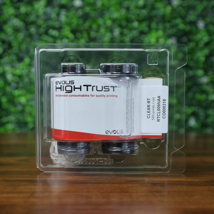 Front label view of the Evolis RTCL009NAA clear transfer ribbon in its sealed High Trust blister packaging, clearly displaying branding, part number, and roll count. Photographed and sold by Specialist ID, an authorized Evolis dealer.