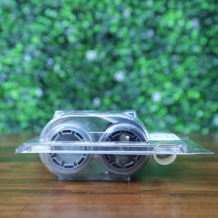 Side view of the Evolis RTCL009NAA clear transfer ribbon showing the plastic reel hubs through sealed blister packaging. Photographed and sold by Specialist ID, an authorized Evolis dealer.