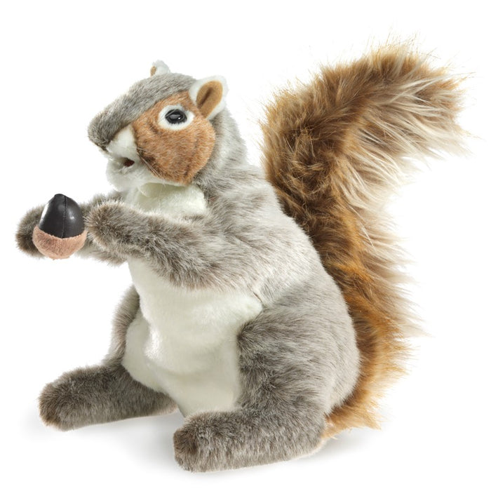 A soft, lifelike gray squirrel hand puppet with fuzzy mixed‑color fur, a movable mouth, poseable head and arms, delicate thread whiskers, and a tiny plush acorn held in its paws.