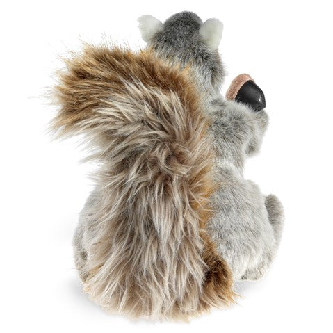 The image shows the back view of a squirrel puppet, focusing on its fluffy brown and ecru tail.