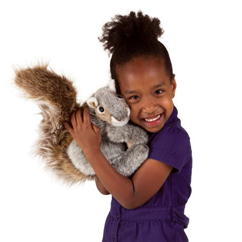 Image features a little girl is hugging the soft, fuzzy grey squirrel puppet.