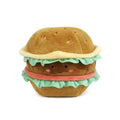 Product title: Hamburger Plushie
A soft hamburger plushie sits stacked with a brown sesame‑seed bun, green lettuce, an orange tomato slice, and a brown patty with a cute smiley face. The plush is made of soft polyester fabric with bright, playful colors.