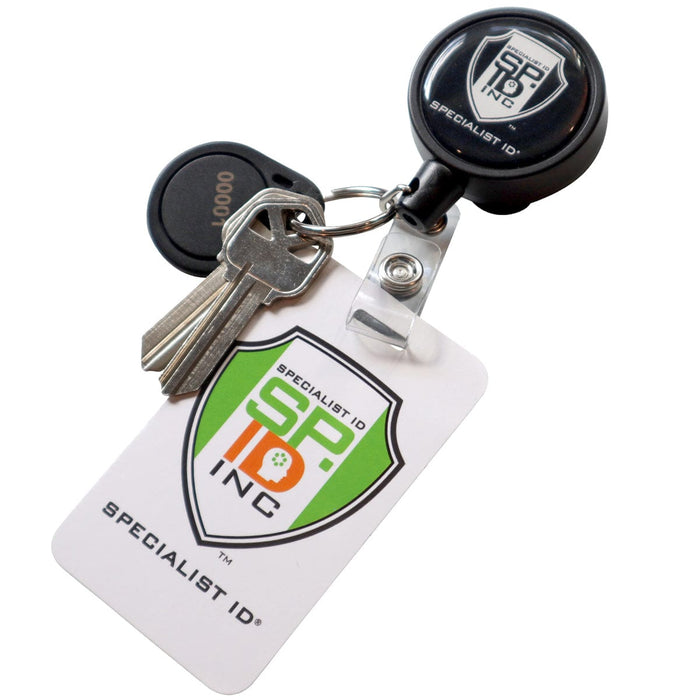 A Heavy Duty Badge Reel w/ Metal Swivel Belt Clip & Key Ring with a "Specialist ID, Inc." logo, featuring a sturdy metal swivel belt clip and holding a white ID card alongside three metal keys.