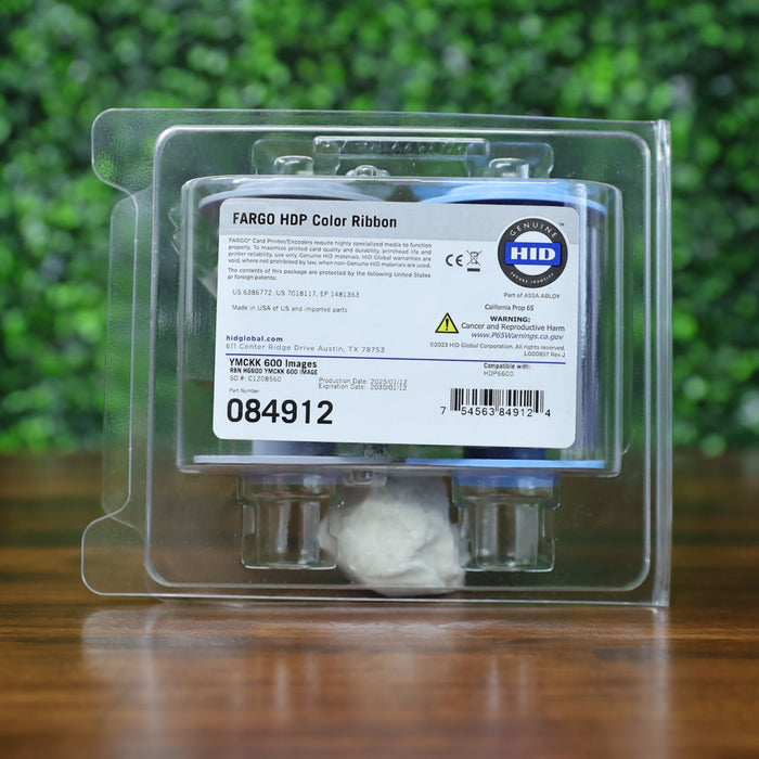 Front-facing view of the HID Fargo 84912 YMCKK ribbon inside sealed clamshell packaging, with product label clearly visible. Photographed and sold by Specialist ID, an authorized Fargo dealer.