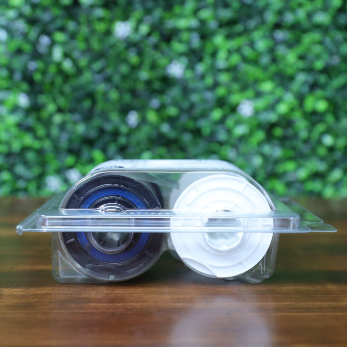 Side profile of HID Fargo 82618 holographic overlaminate in sealed packaging showing black and white spool ends through clamshell case. Photographed and sold by Specialist ID, an authorized HID Fargo dealer.