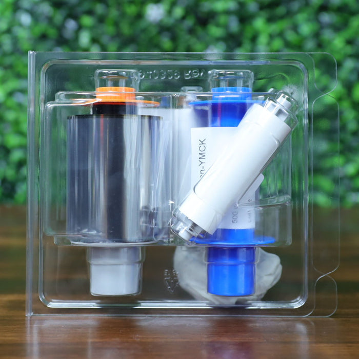 Rear view of HID Fargo 84811 YMCK color ribbon in clamshell packaging, standing upright with orange and blue ribbon spools and label partially visible through clear plastic. Photographed and sold by Specialist ID, an authorized HID Fargo dealer.