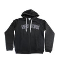 This is a black zip front hoodie made from soft cotton/polyester blend fabric. Across the upper front, the words “NEW YORK” appear in large black letters outlined in white, stretching horizontally across the chest and standing out through contrast and texture. The hoodie fastens with a front zipper and includes flat white drawstrings at the hood. The sleeves and bottom edge have snug, banded cuffs for a comfortable fit.