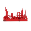 A small, bright red 3D laser‑cut wooden model standing upright, featuring simplified cut‑out shapes of New York City icons—the Statue of Liberty, a classic New York hot dog, the Chrysler Building, a checker cab, and an iconic bridge—with the word “New York” displayed along the base.