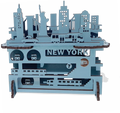 A layered wooden piece with a white background and raised blue shapes you can feel by touch. Smooth, thin wood forms New York City above and below the streets—buildings and landmarks on top, subway lines beneath—stacked to show the city’s depth and motion.