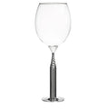Clear wine glass with a metallic base on a white background