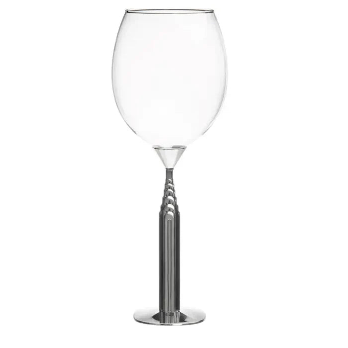 Clear wine glass with a metallic base on a white background