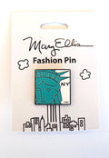 Statue of Liberty Pin:
A simplified, graphic illustration showing a partial view of the face and crown, rendered in bright green with clean, bold outlines and minimal interior detail. The image is immediately recognizable and presented in a flat, iconic style rather than a realistic one. The letters “NY” appear in black to the right of the illustration, set against a white background. The item is shown in its clean illustrated white packaging.