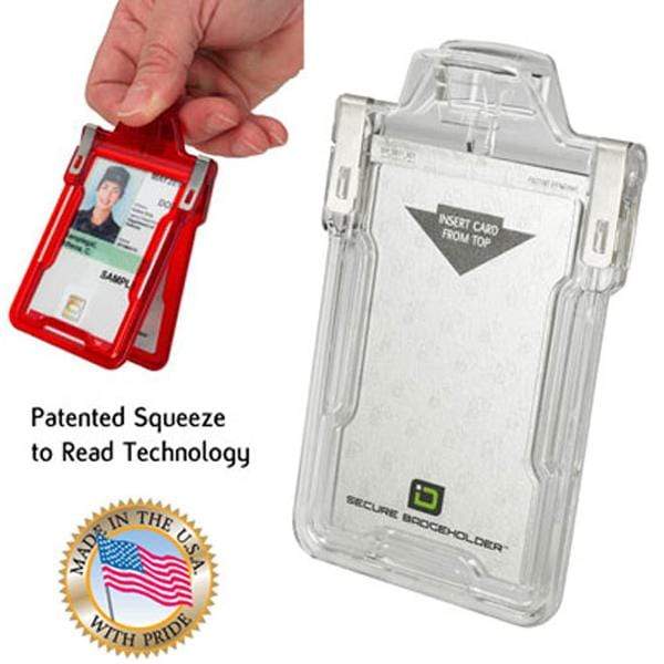 A hand holding a red card reader displaying an ID. Beside it is a clear, secure badgeholder with RFID Blocking. Text reads "Patented Squeeze to Read Technology" along with a "Made in the USA" label displaying an American flag. Product shown: Identity Stronghold RFID Blocking Secure Badgeholder Classic - Holds 1 Card - Shields 13.56MHz Signal (IDSH1004-001B-002).