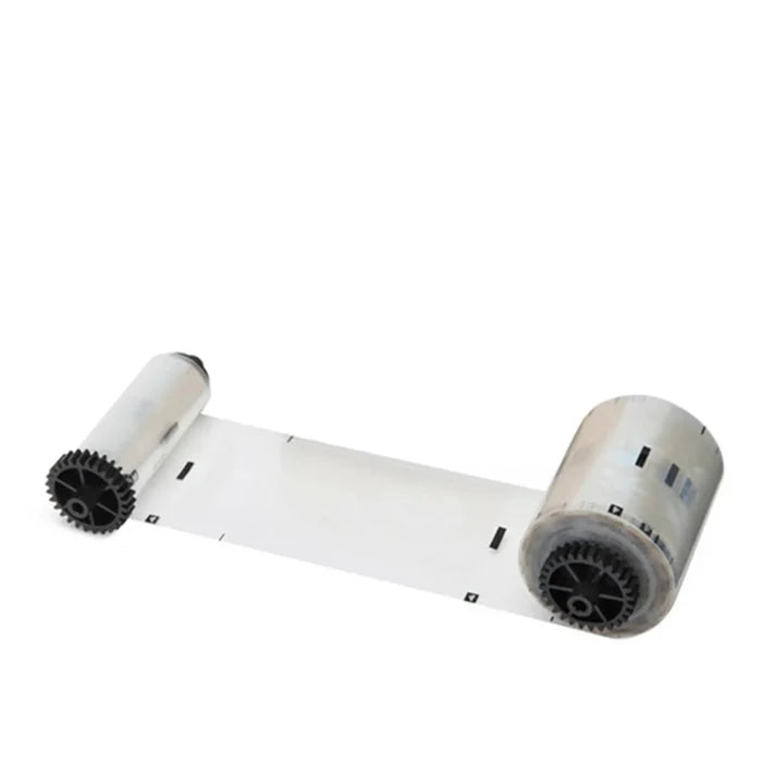A clear plastic film ribbon on two black gear-like rollers, ideal for labels or packaging, pairs perfectly with IDP 659029 Holographic Patch Laminate - 250 Prints, Standard Globe Design.
