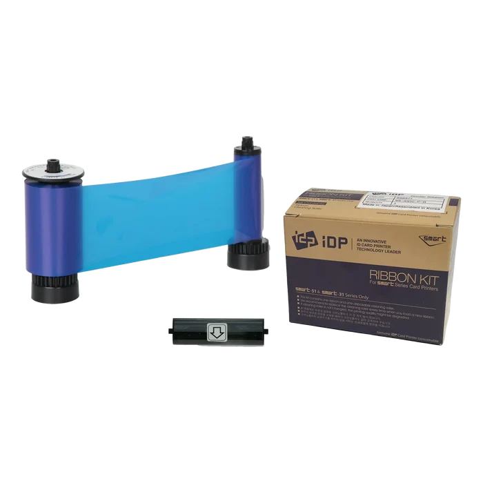 The IDP 659372 Blue Monochrome Resin Ribbon is pictured with two black spools, a cleaning roller, and a beige cardboard box labeled "iDP Ribbon Kit", and is compatible with SMART-31 and SMART-51 ID card printers.