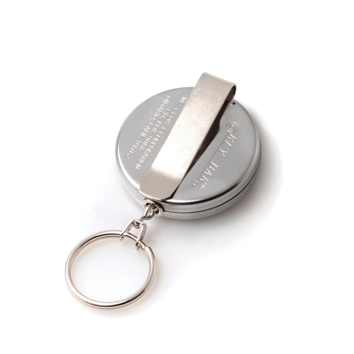 A round, metallic **Key-Bak #5 Self Retracting Key Badge Reel** with an attached keyring and a belt clip, featuring a self-retracting key reel and a sturdy Kevlar cord. Sold by Specialist ID.