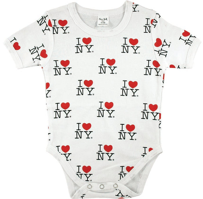 A baby onesie made of soft white fabric is shown laid flat. It’s covered in an all‑over print featuring the classic “I ❤ NY” design. The lettering is bold black, and each heart is a bright red, repeating in a neat pattern across the entire garment — front, back, and sleeves. The high‑contrast red, black, and white colors make the design pop visually. The onesie has short sleeves, three snaps at the bottom, and a simple, clean shape typical of infant clothing.