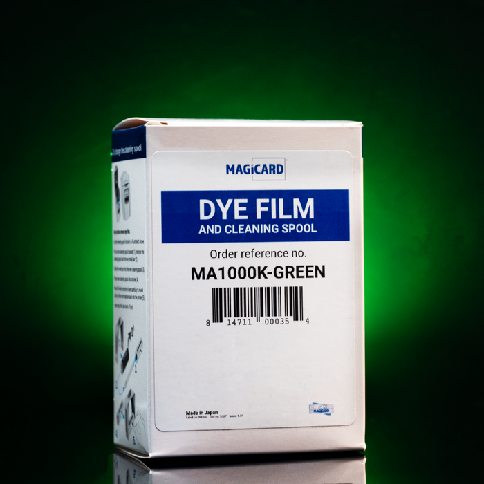 A white box labeled "Magicard MA1000K-GREEN Green Monochrome Ribbon for Enduro+, Enduro3E & Rio Pro, 1,000 Prints" stands against a green background—perfect for users seeking efficient monochrome ID card printing.