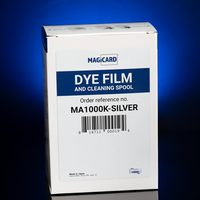 A white box labeled "Magicard MA1000K-SILVER Silver Monochrome Ribbon, 1,000 Prints" for Enduro+, Enduro3E & Rio Pro ID card printers is shown against a blue background—ideal for metallic silver printing.