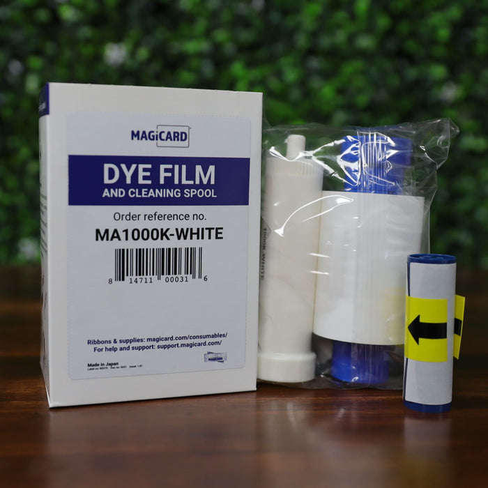 The Magicard MA1000K-White dye film and cleaning spool set for white monochrome card printing. Includes original box, sealed ribbon roll with white and blue spools, and separate cleaning spool with yellow direction label. Designed for use with Magicard printers requiring monochrome output and routine cleaning maintenance. Photographed and sold by Specialist ID, an authorized Magicard dealer.