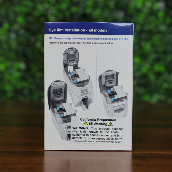 Back of the Magicard MA600KO printer ribbon box showing dye film installation instructions for all models, with a visible California Proposition 65 warning label. Photographed and sold by Specialist ID, an authorized Magicard dealer.
