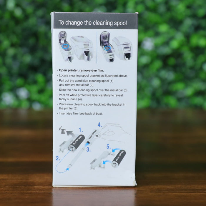 Side view of Magicard PR1000G dye film box showing detailed step-by-step cleaning spool replacement instructions with labeled illustrations and printer diagrams. Photographed and sold by Specialist ID, an authorized Magicard dealer.