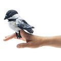 The Mini Chickadee Finger Puppet is a small, soft, puff‑ball‑shaped plush with a velvety black head and tail, gray wings and back, a light fluffy white chest, and tiny firm dark eyes and beak, designed to fit comfortably on a finger.