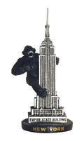 A small 4‑inch souvenir figurine featuring King Kong, the legendary movie monster. The raised 3D design lets you feel the ape gripping the Empire State Building, with clear vertical lines and the words “EMPIRE STATE BUILDING” on the structure. The base features black block lettering with “NEW YORK” below in thick gold letters, easy to read by touch. A bold, fun collectible capturing a classic film moment.
