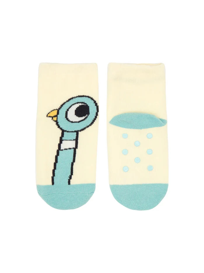 Image shows blue pigeon with a long neck and big bold eyes and a yellow beak against a lemon-yellow background. The other sock is shown from the bottom, displaying rubberized anti‑slip dots across the sole.